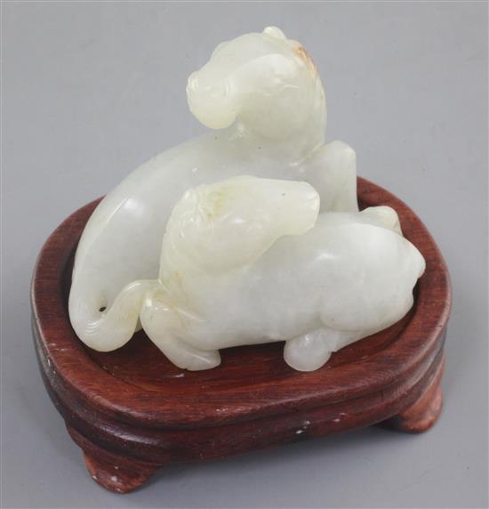 A Chinese pale celadon and russet jade group of two horses, length 6cm